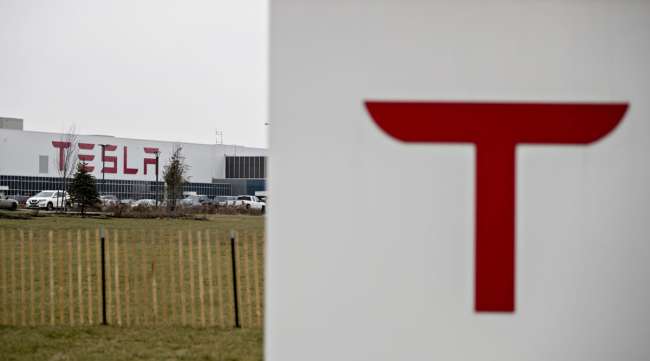 Signage is displayed outside the Tesla factory in Buffalo, N.Y., in December 2018.