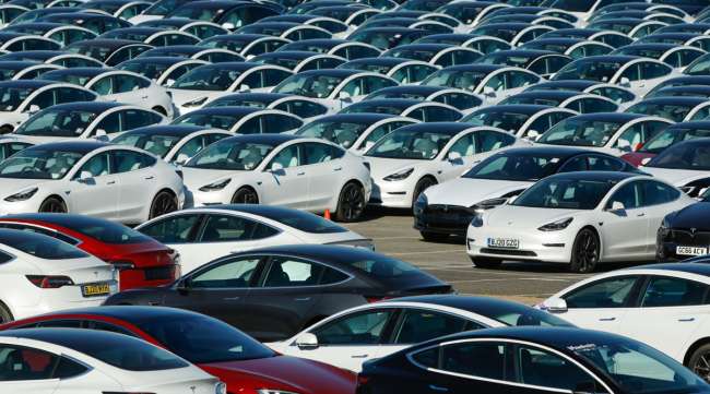 New Tesla vehicles sit in a lot.