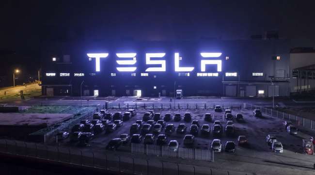 The Tesla Gigafactory in Shanghai, China, stands illuminated at night.