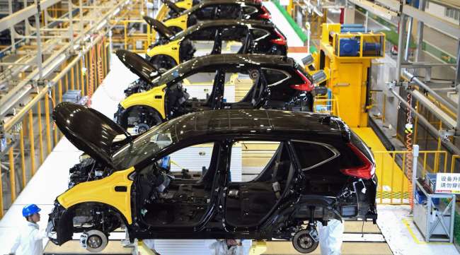 Employees work on a Honda auto plant assembly line in Wuhan in November 2019.