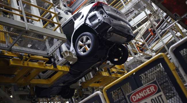 A RAV4 hybrid SUV moves down the assembly line at a Toyota plant in 2019.