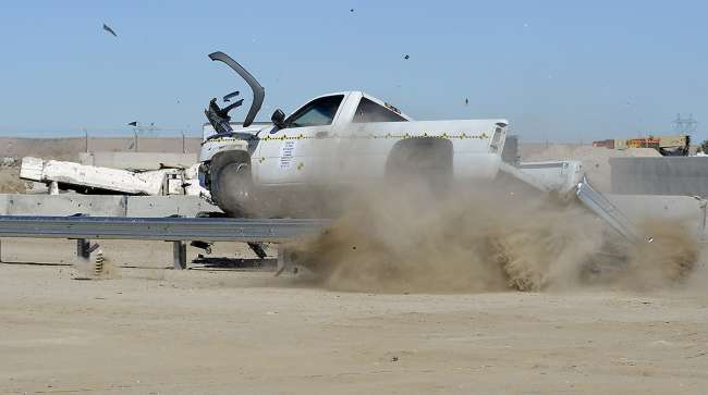 A pick-up truck hits the end of a guardrail head on during a slight angle crash test at Karco Engineering safety testing facility in Adelanto, Calif.