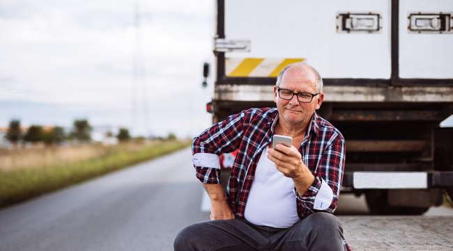 Truck driver checking phone
