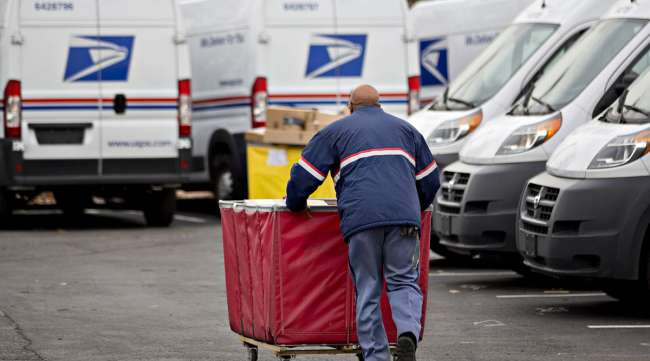 USPS mail truck and delivery driver