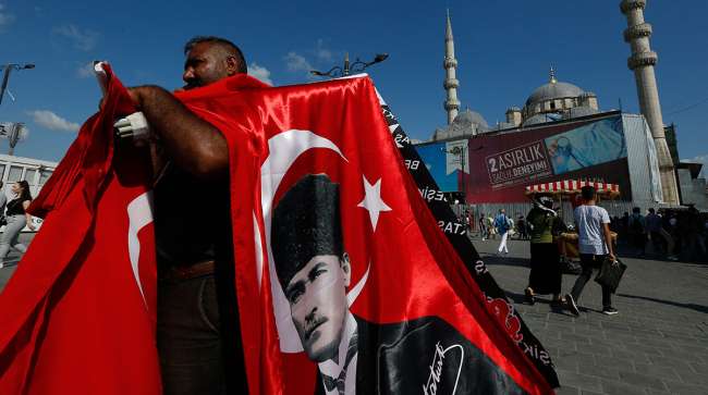 A street vendor offers Turkish flags for sale at a market in Istanbul