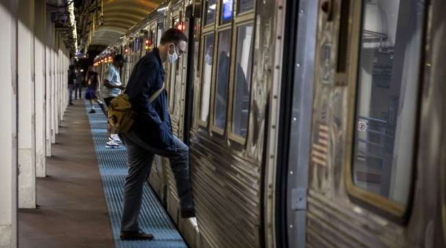 A commuter boards a Chicago Transit Authority train on June 3.
