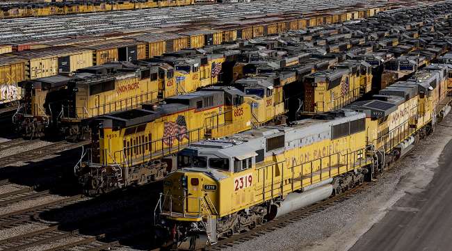 Union Pacific Corp. locomotives and rail cars sit parked at a rail yard in Kansas City.