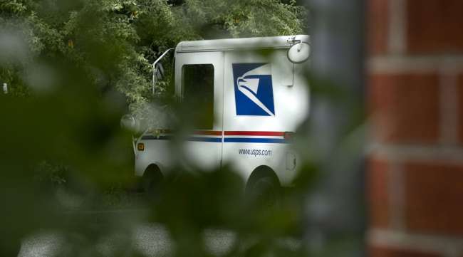 A USPS truck sits at a facility in Elkridge, Md., in August 2020. (Stefani Reynolds/Bloomberg News)