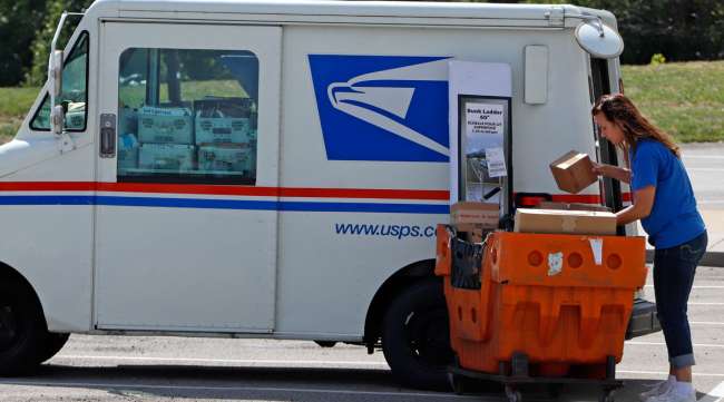 A postal worker loads a delivery vehicle at the post office in Cranberry Township, Pa.