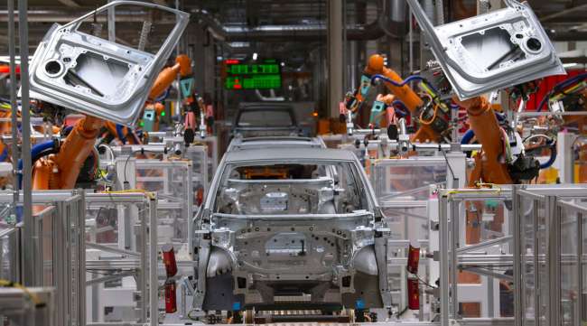 Robots work on the body of a VW ID.3 car at the company's plant in Zwickau, Germany.