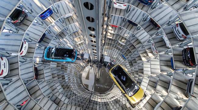 Volkswagen electric vehicles stand inside a delivery tower in Wolfsburg, Germany.