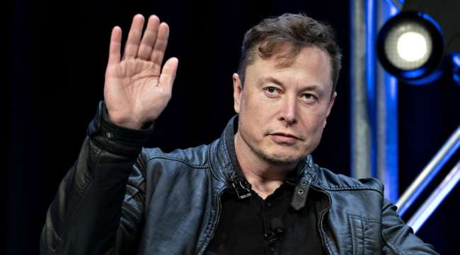 Elon Musk waves during the Satellite 2020 Conference in Washington on March 9.