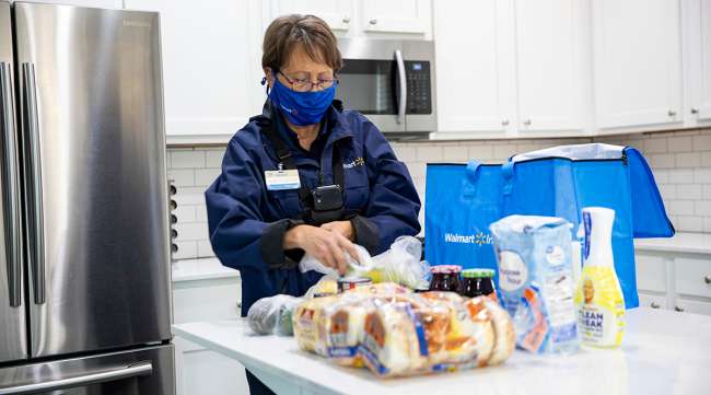 A Walmart InHome driver delivers ambient items in a customer's home.