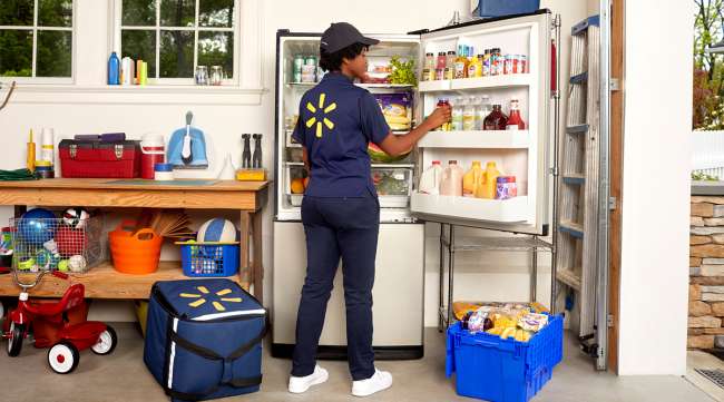 Walmart employee places items inside a customer's refrigerator