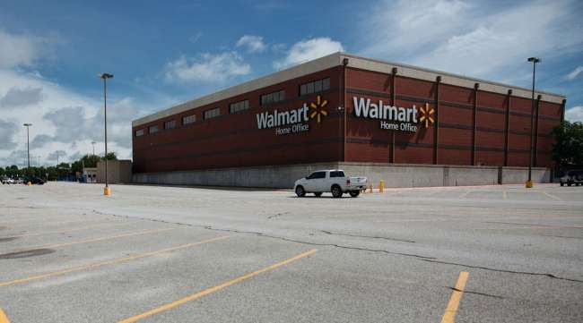 A nearly empty parking lot stands outside the Walmart World Headquarters in Bentonville, Ark., on May 28.