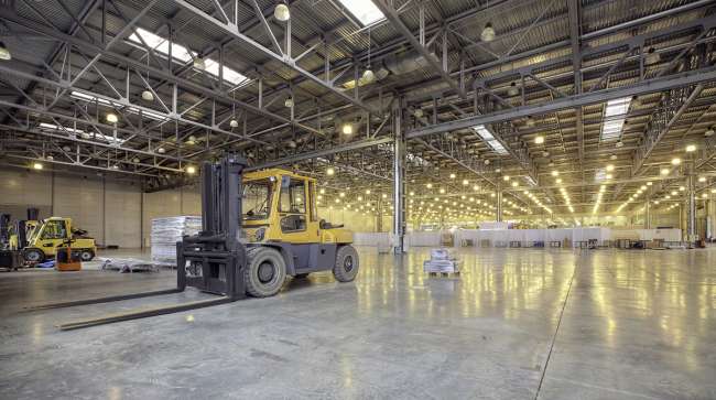 Forklift in empty warehouse