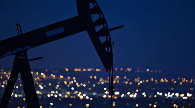 A pumpjack operates above an oil well on the outskirts of Williston, North Dakota.
