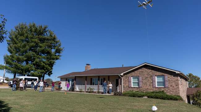 A Wing drone delivers a package to a customer's home in Christiansburg, Va.