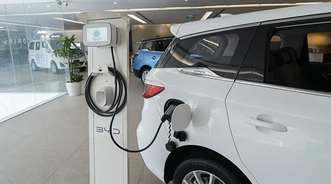 A BYD e6 electric vehicle on display being charged