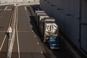 An autonomous tractor tows containers