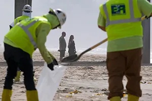 Workers continue to clean the contaminated beach