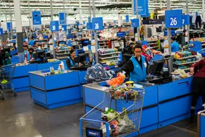 Cashiers process purchases at a Walmart Supercenter