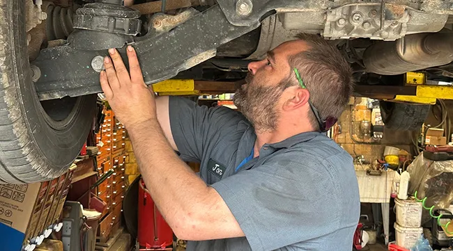 Mechanic inspects pickup truck