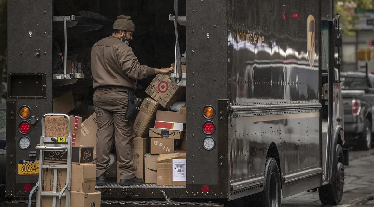 A UPS delivery driver sorts boxes in New York City