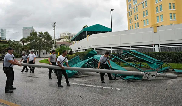 Tampa fire and rescue workers remove street pole