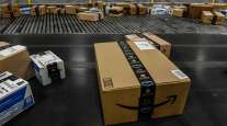 Amazon packages move along a conveyor belt