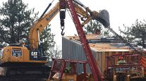 Work crews clean up the derailment of a Norfolk Southern cargo train