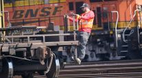 BNSF worker riding railcar