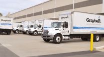 Graybar trucks parked at a loading dock