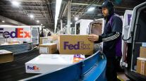 A FedEx worker sorts package