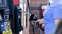 Getty Image of a woman pumping gas