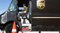A UPS driver leaves from a UPS facility in Landover, Md.