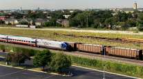 An Amtrak passenger train and a freight train head toward Chicago