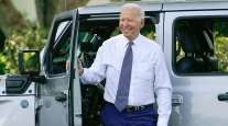 President Joe Biden smiles after driving a Jeep Wrangler 4xe Rubicon on the South Lawn