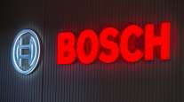  The Bosch logo sits illuminated on a wall at the Robert Bosch GmbH digital factory in Stuttgart, Germany