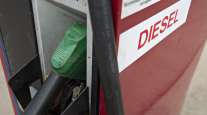 A diesel fuel pump sits in a cradle at a gas station in Tiskilwa, Ill.