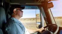A truck driver on a desert highway