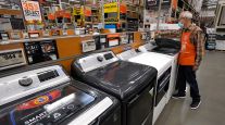  Home Depot worker Javad Memarzadeh of Needham, Mass., dusts washing machines at a Home Depot location in Boston.