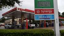 Vehicles refuel at an Exxon Mobil Corp. gas station in Houston on Oct. 28. (Callaghan O'Hare/Bloomberg News)