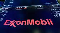 ExxonMobil appears above a trading post on the floor of the New York Stock Exchange