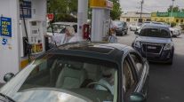 People fill vehicles with fuel at a Royal Dutch Shell gas station in Sumter, S.C.