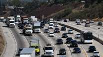 Vehicles drive in traffic on the 405 freeway through the Sepulveda Pass