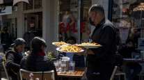 A worker serves food at a restaurant on Pier 39 in San Francisco. (David Paul Morris/Bloomberg News)