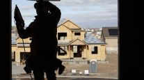 A contractor frames a house under construction in Utah in December 2020. (George Frey/Bloomberg News)
