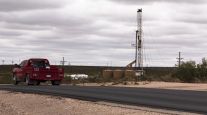 A truck passes a horizontal drilling rig in Lea County, N.M.