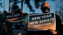 A person holds a "New Year New Senate" sign during a "Get Out the Vote" event in Georgia on Jan. 3.